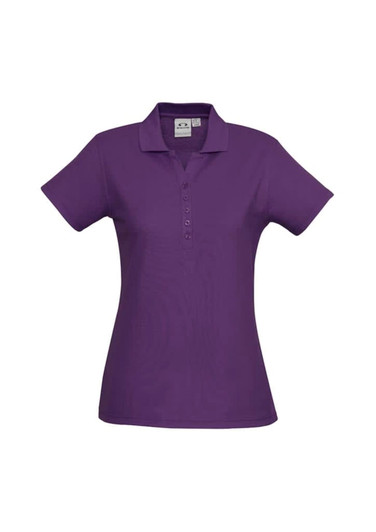 A purple ladies' polo shirt with a collared neck and button placket, featuring a logo on the chest.