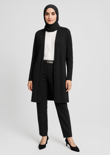 A black longline cardigan worn over a white top and black trousers, styled with a belt and a hijab.
