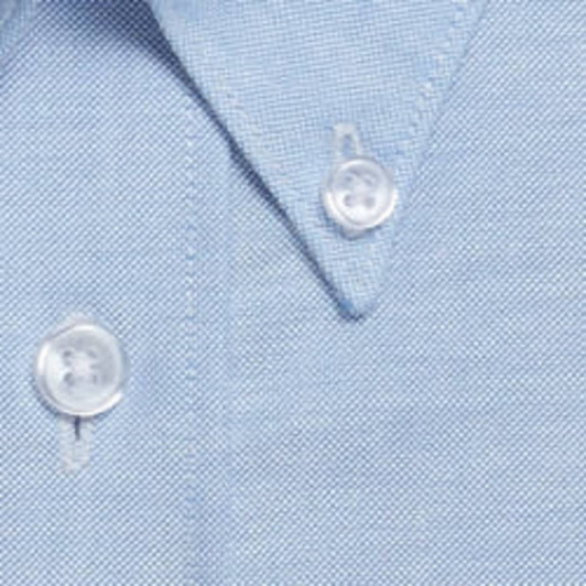 A light blue button-up shirt featuring a textured fabric and clear plastic buttons.