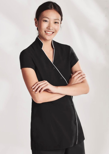 A black women's crossover tunic with short sleeves and white piping, featuring a button closure and a logo.