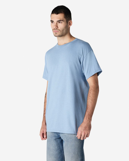 A blue Gildan Ultra Cotton adult t-shirt worn by a person, featuring a simple design and a logo.