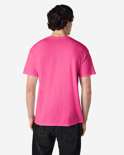 A back view of a pink Gildan Heavy Cotton Adult T-Shirt. The shirt features a logo on the upper back.