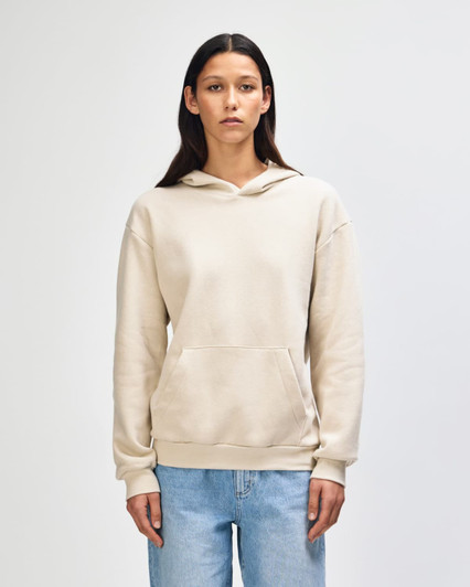 A unisex hooded sweatshirt in a light beige colour, featuring a front pocket and a hood. It has a branding logo.