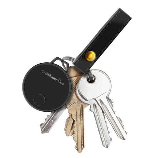 A black SwiftFinder Duo Smart Global Tracker attached to a keyring with several keys. Includes a leather strap.