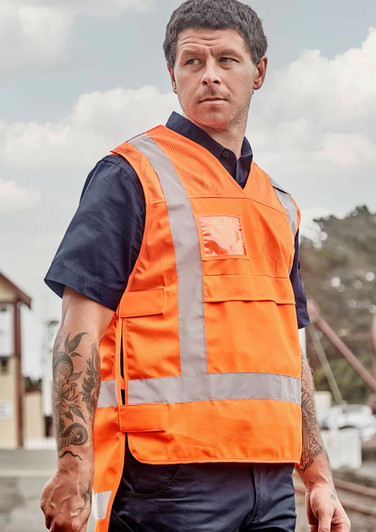 A unisex hi-vis safety vest in bright orange, featuring reflective strips and pockets, shown on a model.