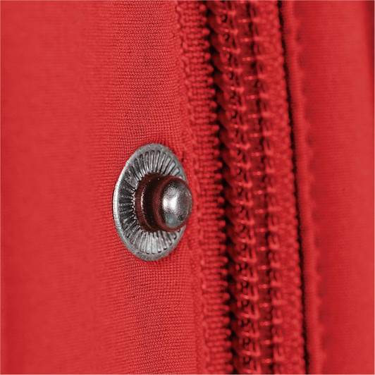 A close-up of a red jacket featuring a metal snap button and a zipper.