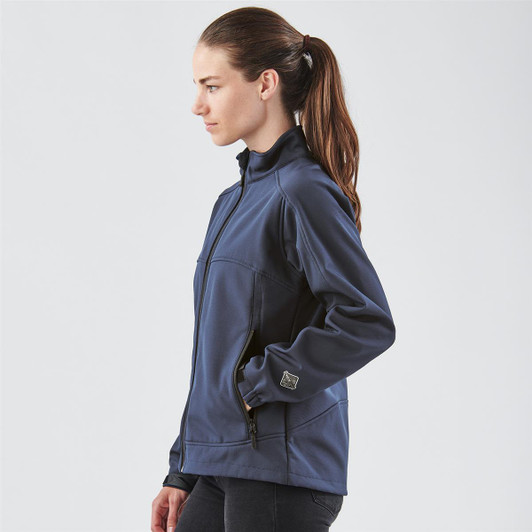A navy women's jacket with a zip front, featuring a high collar and side pockets. The model is shown from the side.