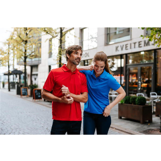 A red polo shirt and a blue polo shirt displayed on a couple walking through an urban street. Both shirts have logos.