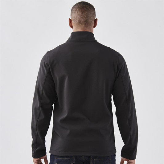 A softshell jacket in black, featuring a stand-up collar, viewed from the back. It has a logo.