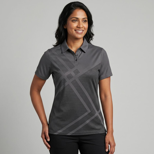 A women's polo shirt in grey with a geometric pattern and a collar. It features a logo on the chest area.