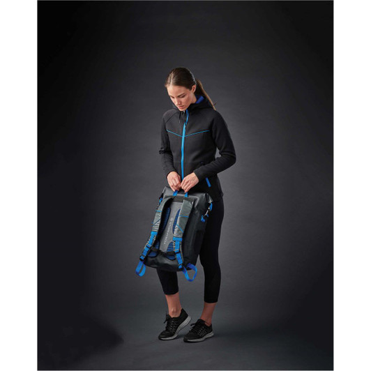 A woman wearing a black women's Logan Performance Hoody with blue accents, holding a bag against a dark background.