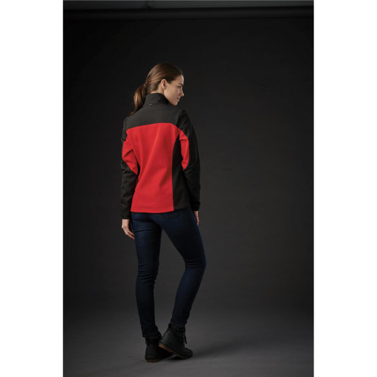 A women’s softshell jacket featuring a black and red design, displayed from the back against a dark background.