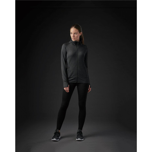A women's Pacifica jacket in black, featuring a zip front and a modern fit, paired with black leggings and shoes.
