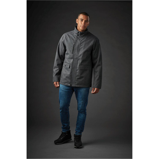 A men's Montauk System jacket in dark grey, featuring a high collar and front pockets, worn with blue jeans.