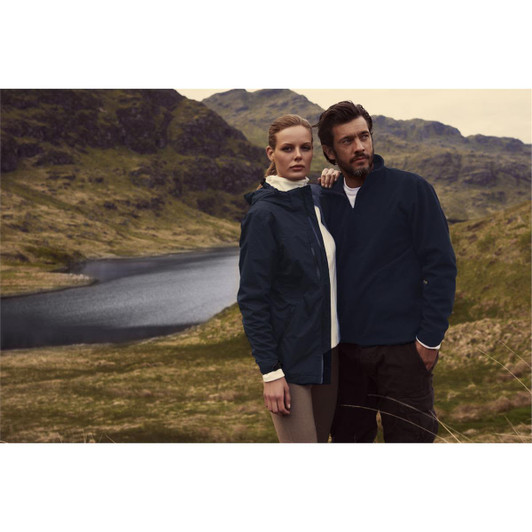 A men’s navy rain jacket displayed on a model, surrounded by a scenic landscape with water and greenery.