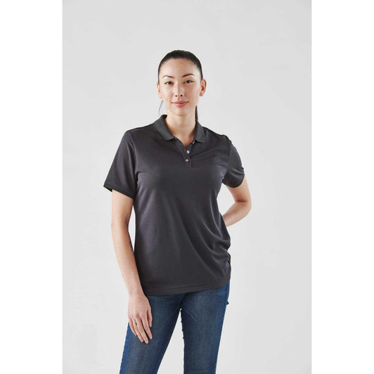 A women's polo shirt in dark grey, featuring a classic collar and short sleeves, with a subtle logo present.
