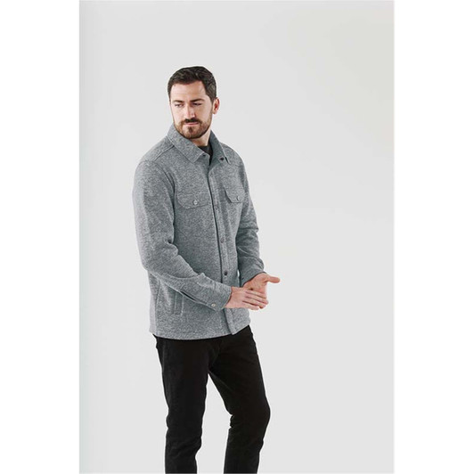 A man wearing a grey unisex fleece shacket with front pockets, set against a light background.