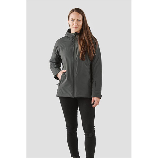 A woman wearing a dark grey women's thermal shell jacket, featuring a hood and a sleek design.