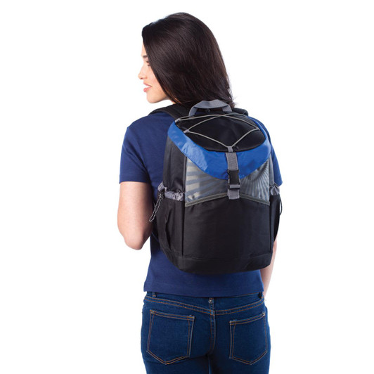 A backpack cooler in black and blue, featuring a logo, worn by a woman from the back.