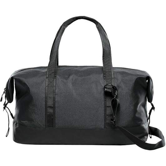 A dark green duffle bag with black accents, featuring two handles and an adjustable shoulder strap. It has a logo.