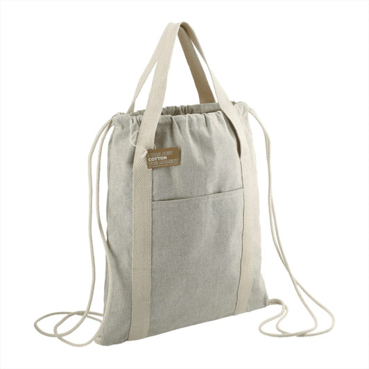 A light grey recycled cotton drawstring bag with two straps and a front pocket. It features a logo on the side.
