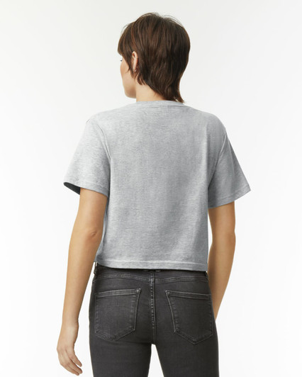 A grey women's boxy t-shirt featuring short sleeves and a cropped design, displayed from the back.