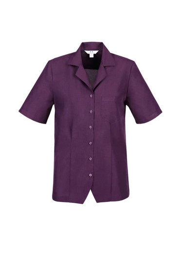 A purple ladies overblouse with short sleeves, a collar, and a single chest pocket, featuring a logo.