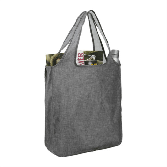 A large grey reusable tote bag with two shoulder straps, containing a drink bottle and a magazine.
