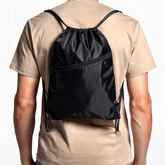 A black drawstring bag is worn on a person's back, featuring a front pocket and adjustable straps.