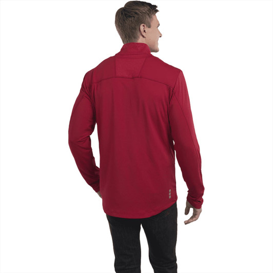 A man wearing a red knit quarter zip jumper, viewed from the back. The jumper has a logo on it.