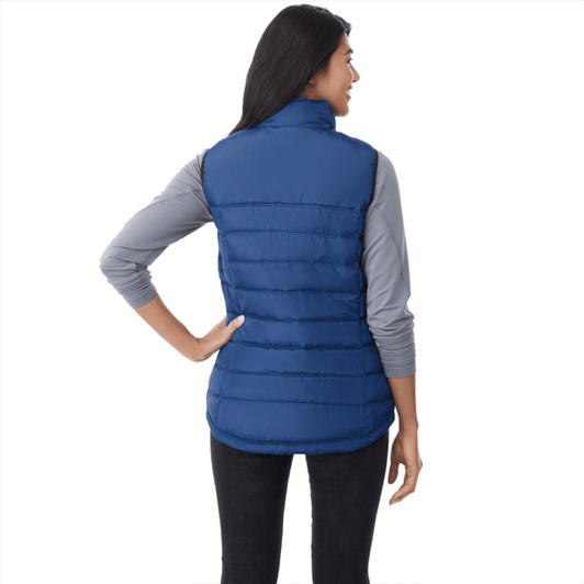 A blue women's insulated vest with a high collar and horizontal quilted design, featuring a logo.