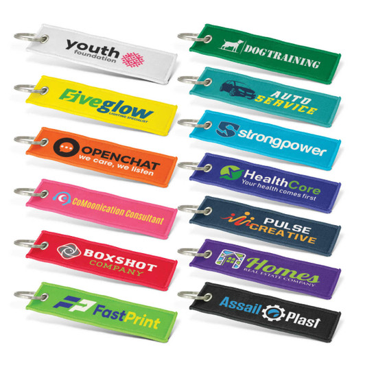 Woven key rings in various colours, each featuring a different logo or branding.
