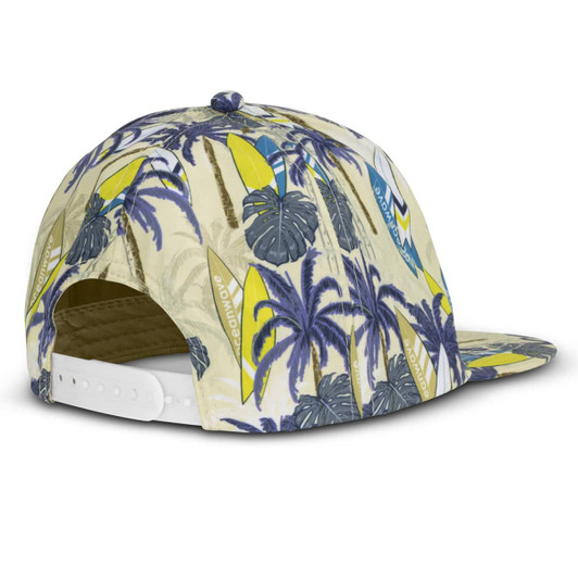 A flat peak cap in beige with a vibrant palm tree and surfboard design, featuring a white adjustable strap at the back.
