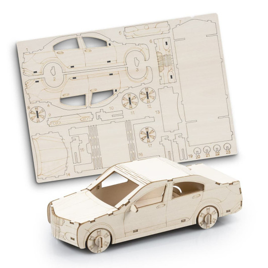 A wooden model car kit with unassembled parts displayed on a flat sheet. The model is light beige in colour.