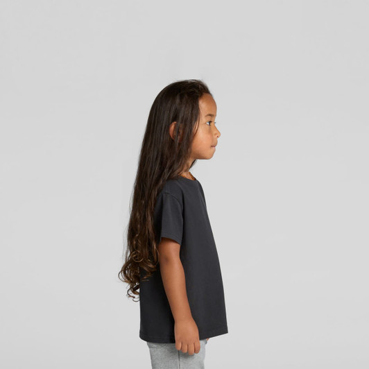 A black kids' heavy faded tee displayed on a child with long hair, set against a plain background.