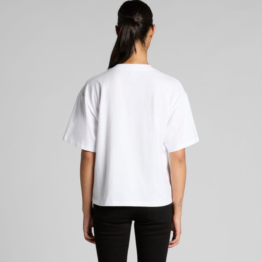 A white V-neck T-shirt with a loose fit, shown from the back. The model is wearing black jeans.