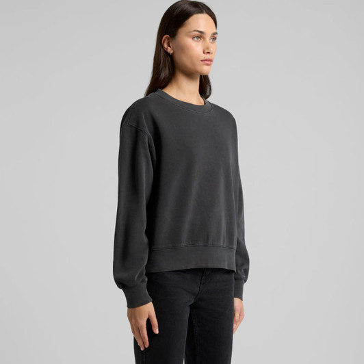 A grey faded crew jumper with long sleeves displayed on a model. The design features a relaxed fit and a subtle logo.