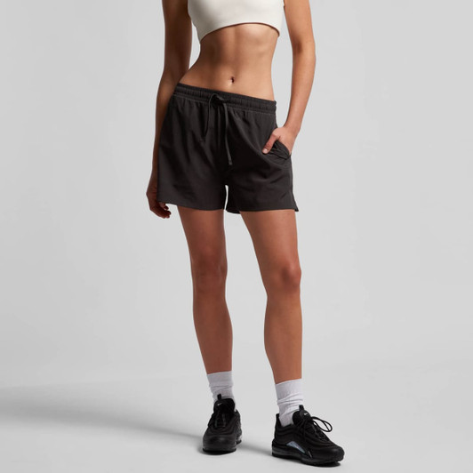 Active shorts in dark grey, featuring an elastic waistband, drawstring, and side pockets, worn with a cropped top.