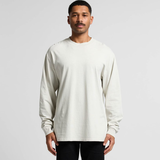 A light cream long sleeve tee displayed on a model, featuring a relaxed fit and a logo.