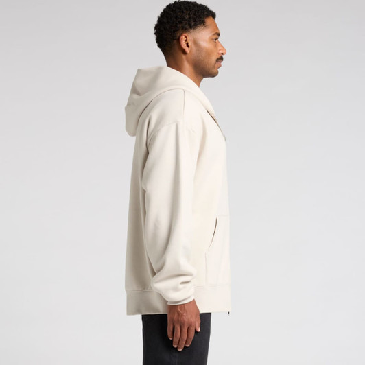 A side view of a beige heavy zip hoodie featuring a hood and a pocket, with a logo on it.