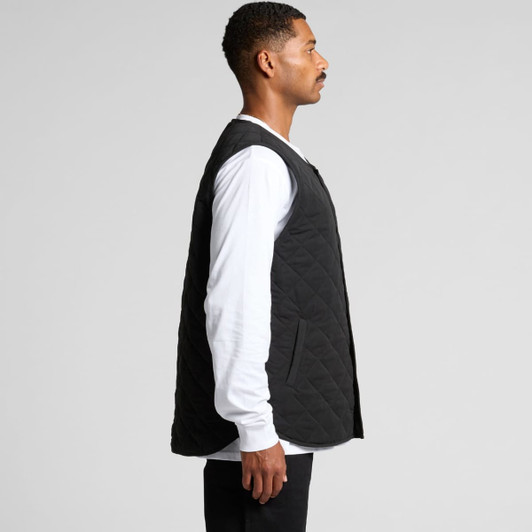 A black quilted vest is displayed, featuring a side view with a person wearing a long-sleeve white shirt underneath.