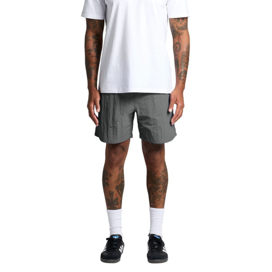 A pair of grey swim shorts with a loose fit, featuring an elastic waistband and a logo detail.