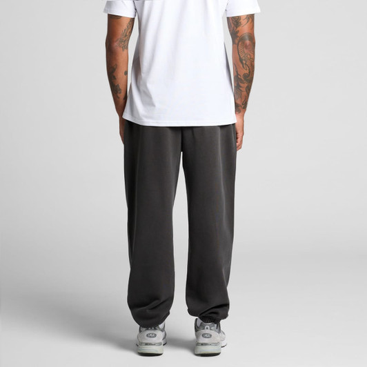 Faded track pants in dark grey, featuring a relaxed fit with a waistband and a logo.