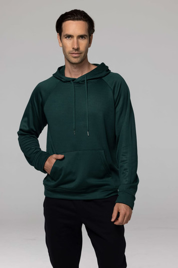 A green men's hoodie with a front pocket and a hood, featuring a logo. Model is standing with hands in pocket.