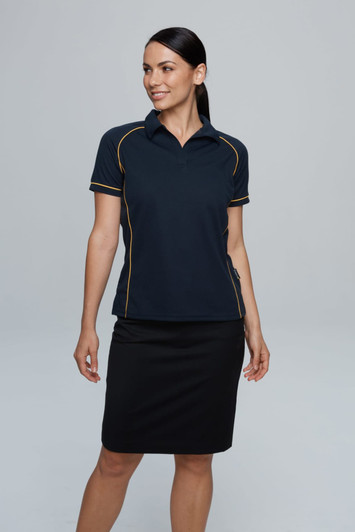 A navy polo shirt with yellow piping, worn by a model, paired with a black skirt. It features a branding logo.