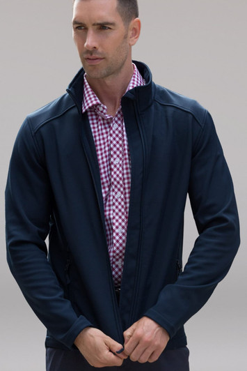 A navy soft shell jacket worn by a man, featuring a zippered front and a collar. It has a logo on it.