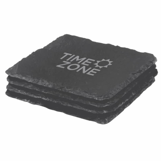 A set of four black slate coasters stacked together, featuring a logo on the top coaster.