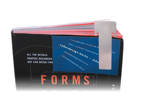 A silver rectangle clip on a black and red book, holding a blue business card with a logo.