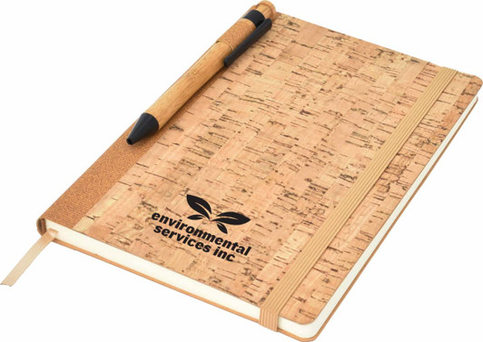 A cork-covered A5 notebook with an elastic band and a pen, featuring a logo on the front.