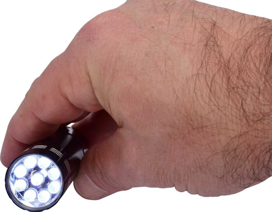 A hand holding a black mini torch featuring multiple bright LED lights. The torch includes a branding logo.
